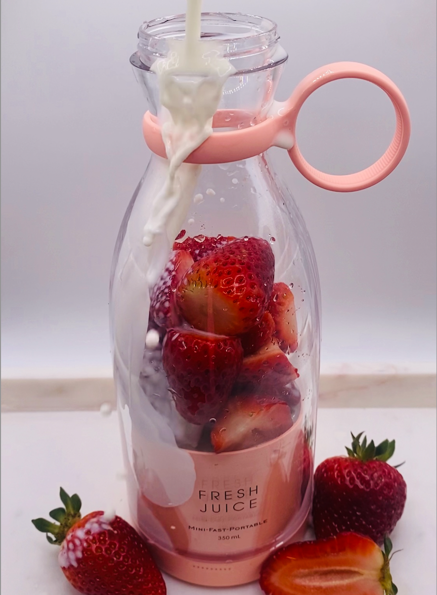 Load video: Video of blender blending strawberries and milk.